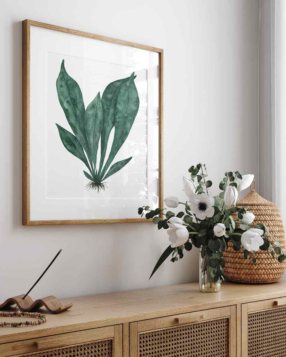 Wall art print of green tropical leaves in oak frame Driftwood Interiors